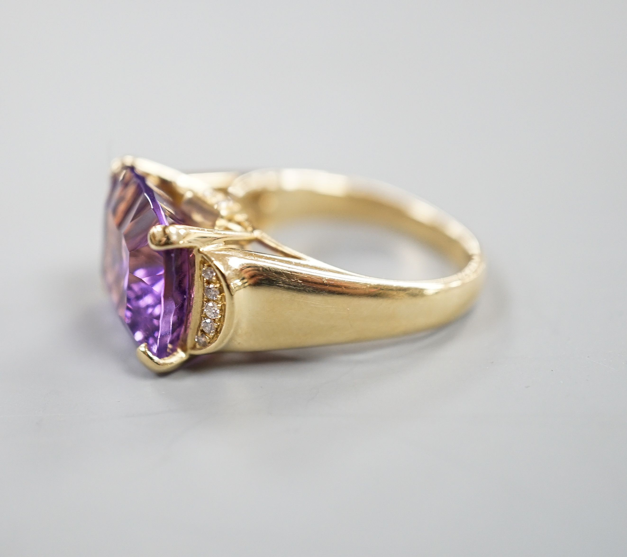 A modern 14k yellow metal, fancy cut amethyst and diamond chip set dress ring, size P/Q, gross weight 8 grams.